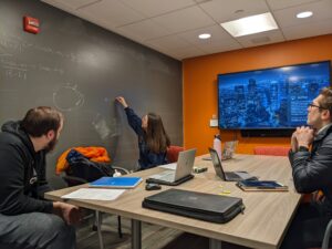 Group of research students working together on a blackboard